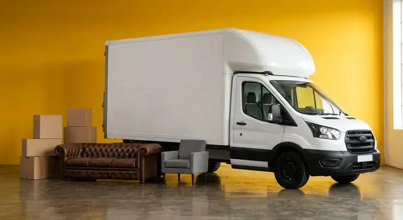 Vehicall Transport Luton van with furniture on a yellow studio backdrop